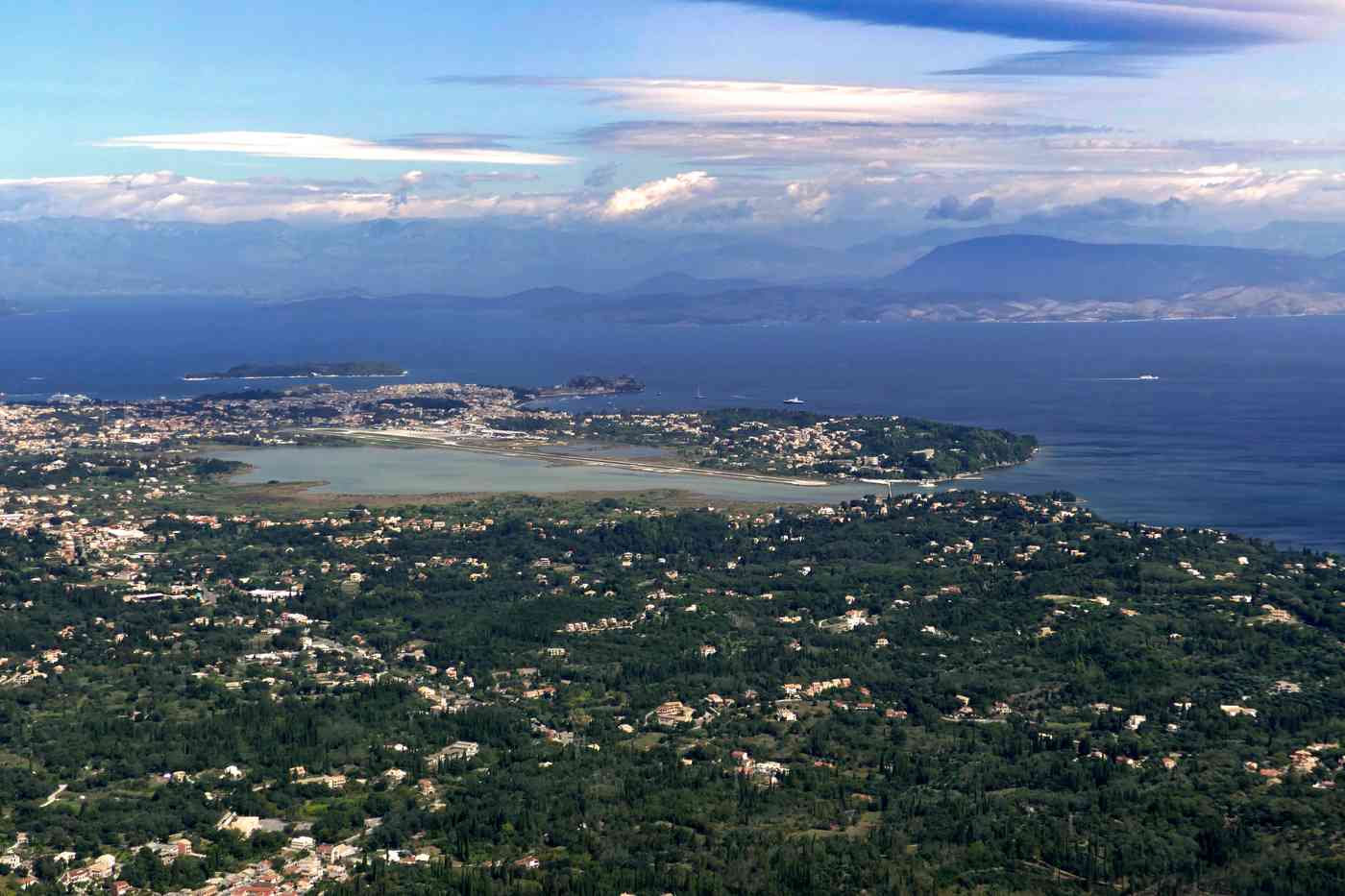 Corfu Airport CFU — the runway on the lagoon spit with Corfu Town beyond